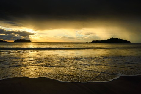 Sunset in Penca Beach, Guanacaste, Costa Rica showing distant rain. Photo by Eduardo Libby